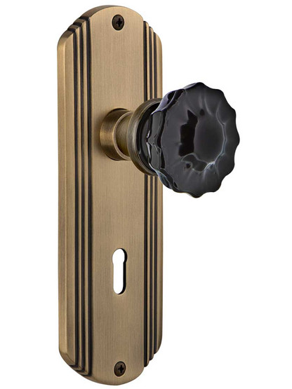 Streamline Deco Door Set with Colored Fluted Crystal Glass Knobs and Keyhole Black in Antique Brass.